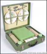 A vintage mid 20th century Brexton picnic hamper case in a green finish.