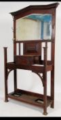 A late Victorian oak hall stand, with mirror back above a single drawer box,