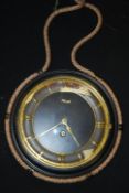 A vintage retro mid 20th century rope hanging Kienzle wall clock with a black and gilt finish.