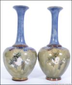 A pair of Royal Doulton vases of shouldered oviform with high necks,