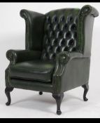 Antique Chesterfield Style mahogany and leather button back armchair being raised on cabriole legs