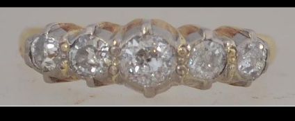 An 18ct five stone ring set with approx 50pts diamonds. Marked 18ct. Tests 18ct gold. Size L.