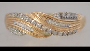 A hallmarked 14ct gold and diamond ring set with square and round cut channel set diamonds.