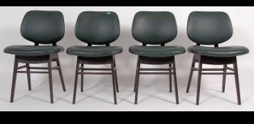 A set of 4 1950's green vinyl upholstered dining chairs in the manner of Benchairs being raised on