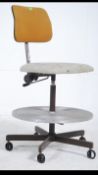 A vintage mid 20th century industrial machinist swivel chair having padded seat and adjustable
