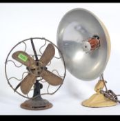 A vintage metal and brass blade mid century desk fan with caged blades together with a 1950's Ergon