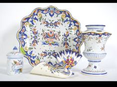 A group of Rouen Faience ceramics to include large cheese plate, puzzle vase, wall pocket,