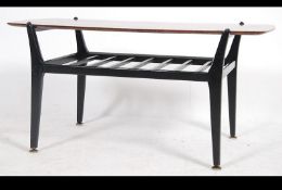 A retro / vintage mid 20th century Danish inspired teak wood coffee table being raised on ebonised
