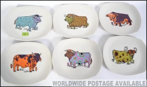 A set of original retro 1970's Beefeater plates each with a different style of cow pattern and