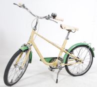 A 1950's retro mid century two tone childs bicycle in cream and green with saddle and stand
