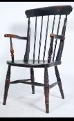 A Victorian beech and elm Windsor chair raised on turned legs with stretchers having saddle seat