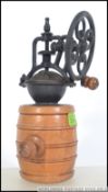 A 20th century antique style top feeding coffee grinder in the for of a barrel with side hand