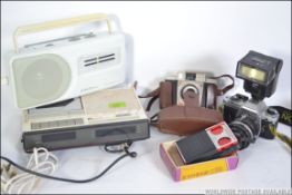 A Nikon FG slr camera with lens and flash together with a Roberts RP15 radio,