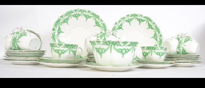 An early 20th century Foley china ceramic tea service in a green and white pattern,