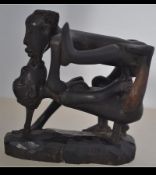 A carved erotic wooden figurine with notation to the base for Simon Kopy RC 167 Boko Dares Salaam