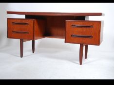 A 1970's G-Plan Fresco pattern teak wood writing table desk having a series of drawers with