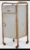 A mid century retro Industrial metal medical cabinet trolley on castors with exterior tubular frame