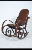 A vintage 20th century Thonet style bentwood rocker / rocking chair with brown leather quilted seat