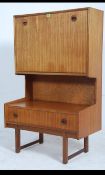 A vintage mid 20th century Danish style teak wood drinks cabinet on cross legs with lower drawer