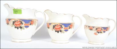 A set of three early 20th century transfer printed graduating jugs each with floral print to the