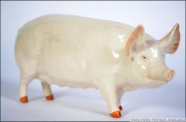 A Beswick figure of a pig bearing Ch Wall Queen 40, printed and painted marks to the base.