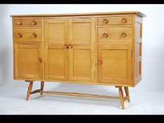 A rare retro Ercol light elm small sideboard with an unusual configuration of drawers and cupboard