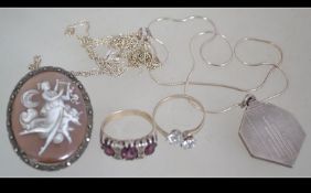 A selection of white metal jewellery to include pendant necklace rings and a cameo brooch.