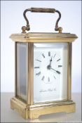 An early 20th century carriage clock having enamel facia with roman numeral chapter ring and