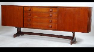 A 1950's Vanson teak wood sideboard raised on angled supports with rounded ends having a central
