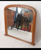 A good Victorian style arched pine overmantel mirror with back panels in place having central plate