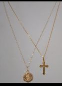 Two 9ct gold pendant necklaces one strung with a crucifix the other with a St Christopher.