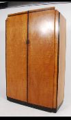 A 1930's Art Deco satin birch double wardrobe having inset plinth base,