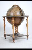 A 20th century cocktail drinks globe set to a shaped base with detail.