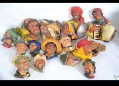 A collection of 19 Bosson's plaster wall masks in the form of heads together with animals ( see
