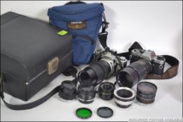 A vintage 35mm Olympus camera with telephoto lens and various accessories in original case with