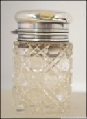 An early 20th century silver hallmarked and cut glass ladies perfume bottle with stopper.