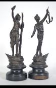 A pair of Spelter figurines from the mid 20th century to include one marked ' Le Pouvoir ' both