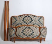 An early 20th century French bow fronted corbeille bed with chenille upholstered head and footboard