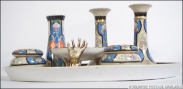 An early 20th century Art Deco Noritake dressing table set of oval tray, pair of candle sticks,
