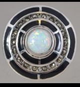 A contemporary ladies silver onyx adorned ring with large central opal in the Art Deco style.