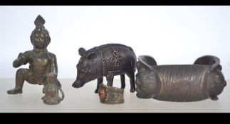 A collection of bronze and brass items to include a bronze pig, brass deity figurine,