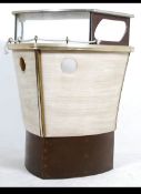 A retro 1950's cocktail drinks bar in the form of a boat having rope front with shelved interior.