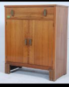 A 20th century Art Deco walnut tall boy with a single long drawer over two doors opening to reveal