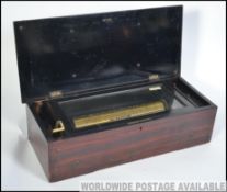 A 19th century Rosewood / mahogany 8 Aires cylinder music box having hinged top above.