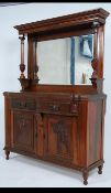 An Edwardian mahogany Art Nouveau mirror back sideboard dresser being raised on shaped feet having
