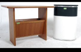 A 1970's Danish teak wood magazine rack with labels to the underside together with a retro two tone