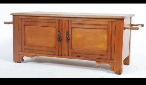 A late 19th century Victorian walnut and oak low cupboard window seat with a pait of doors opening