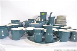 An extensive Poole pottery with a greyish blue finish consisting of coffee pots, tea pots,