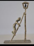 A silver hallmarked figurine believed Dutch with Rotterdam marks of a lamplighter up his ladder