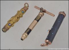 3 yellow metal early 20th century propelling pencils to include a Perry and Co metamorphic 3 draw